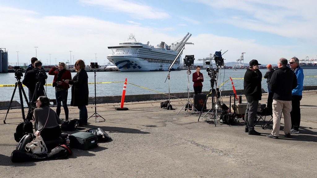 Journalists set up at the Port of Oakland, California, on March 10, across from the cruise ship Grand Princess. Passengers had begun to disembark after 21 people on board tested positive for COVID-19. (Justin Sullivan/Getty Images)