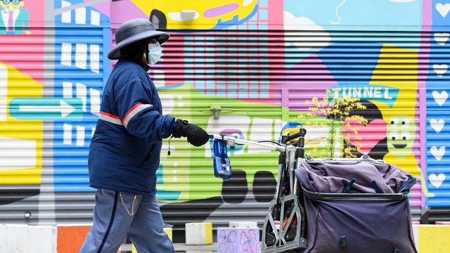 A U.S. Postal Service worker walks in New York City on April 30, 2020. (Noam Galai/Getty Images)