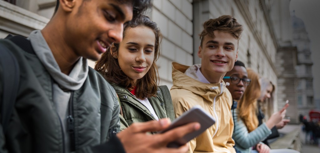 Teenagers students using smartphone on a school break