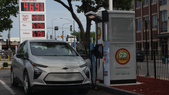 An electric car charges near a gas station on May 21, 2024, in Chicago. (Scott Olson/Getty Images)