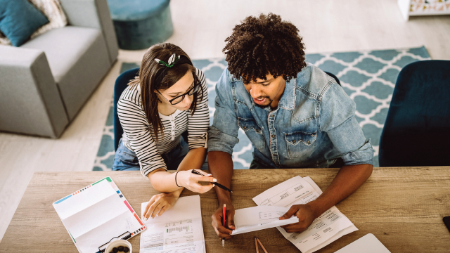 Couple calculating financial bills at home