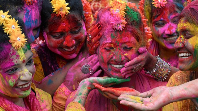 Girls celebrate the Holi festival with colorful powders in Kolkata, India, on March 14, 2025. Hindus have one of the highest retention rates around the world: Just 1% have switched religions since childhood. (Dibyangshu Sarkar/AFP via Getty Images)