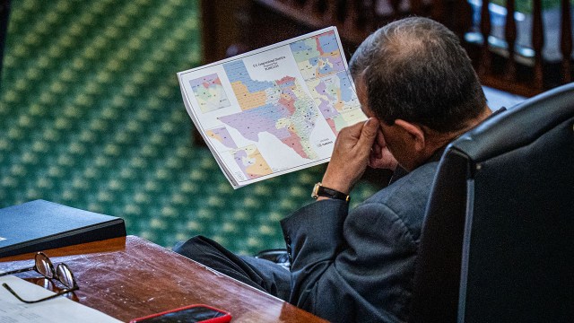 Texas state Sen. Pete Flores, R, looks at a proposed redistricting map on Aug. 22. The Senate went on to pass a midcycle redistricting bill early the next day. (Sara Diggins/The Austin American-Statesman via Getty Images)