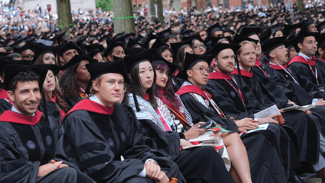 Students attend a graduation ceremony at Harvard University in Cambridge, Massachusetts, on May 29, 2025, days after the Trump administration moved to bar Harvard from enrolling international students. (Selcuk Acar/Anadolu via Getty Images)