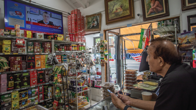 A shopkeeper watches news of U.S. and Israeli attacks on Iran at his Iranian market on Persian Square in the Westwood neighborhood of Los Angeles on Feb. 28, 2026. (Apu Gomes/AFP via Getty Images)