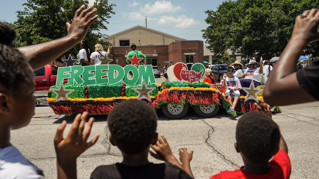 Spectators watch a Juneteenth parade on June 19, 2021, in Galveston, Texas. (Go Nakamura/Getty Images)