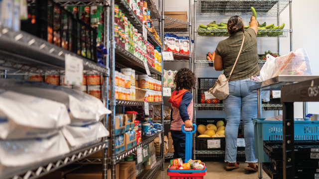 A family browses food pantry shelves in Austin, Texas, on March 26, 2025. (Brandon Bell/Getty Images)